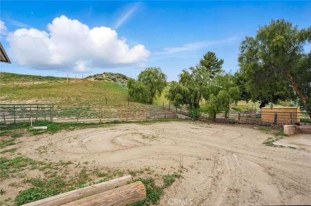 view of yard with a rural view and an enclosed area