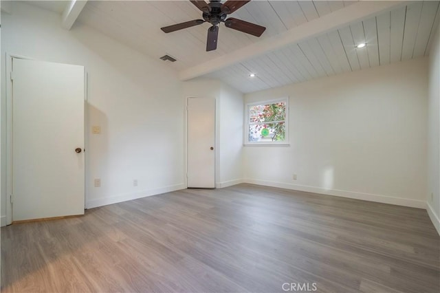 empty room featuring visible vents, ceiling fan, vaulted ceiling with beams, and wood finished floors