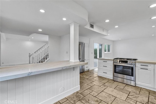 334 Tours Ln, Costa Mesa, CA 92627 - kitchen with appliances with stainless steel finishes, white cabinetry, stone tile floors, recessed lighting, and light stone countertops