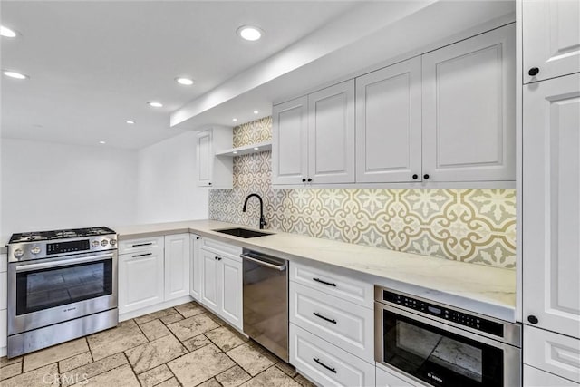 334 Tours Ln, Costa Mesa, CA 92627 - kitchen featuring stainless steel appliances, backsplash, recessed lighting, light stone counters, and white cabinetry