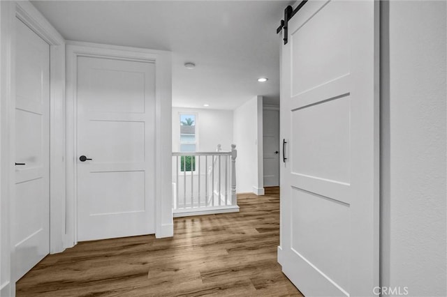 334 Tours Ln, Costa Mesa, CA 92627 - corridor with wood finished floors, recessed lighting, an upstairs landing, and a barn door