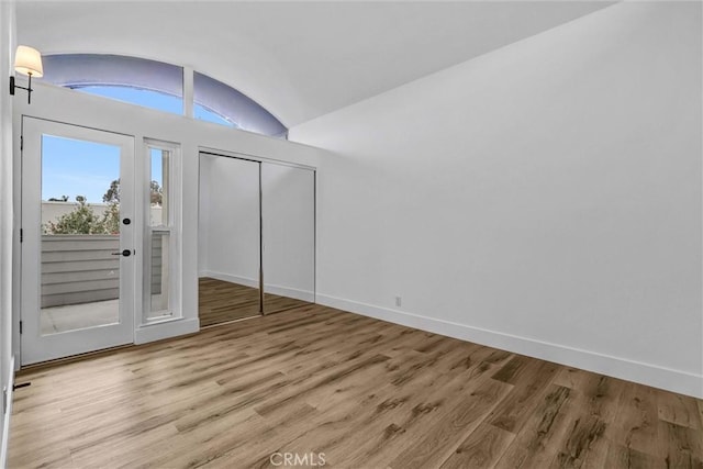334 Tours Ln, Costa Mesa, CA 92627 - unfurnished bedroom with wood finished floors, lofted ceiling, a closet, and access to outside