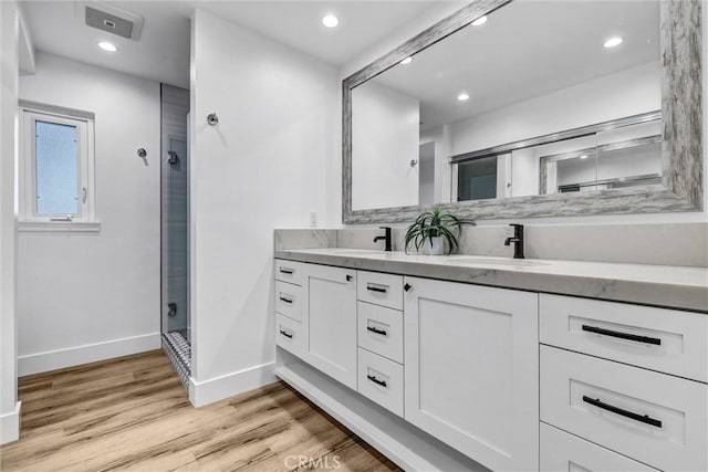334 Tours Ln, Costa Mesa, CA 92627 - full bath with double vanity, a stall shower, wood finished floors, and recessed lighting