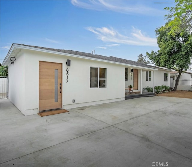 8519 Wakefield Ave, Panorama City, CA 91402 - view of front of home featuring a patio area, a porch, stucco siding, and fence