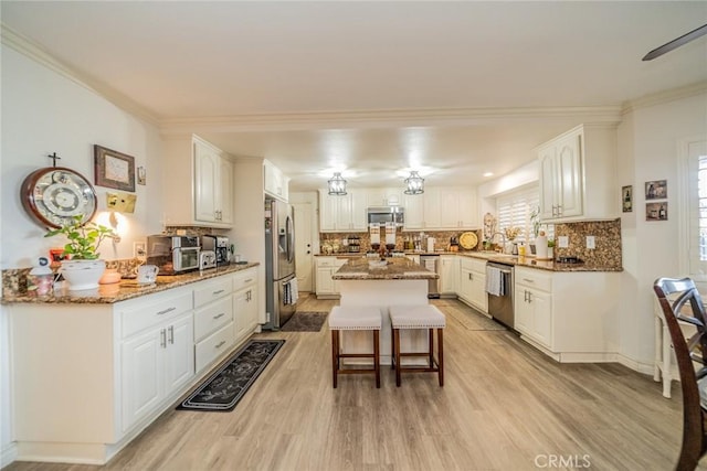 9527 Manzanita Dr, Rancho Cucamonga, CA 91737 - kitchen with a sink, light wood finished floors, backsplash, appliances with stainless steel finishes, and light stone countertops