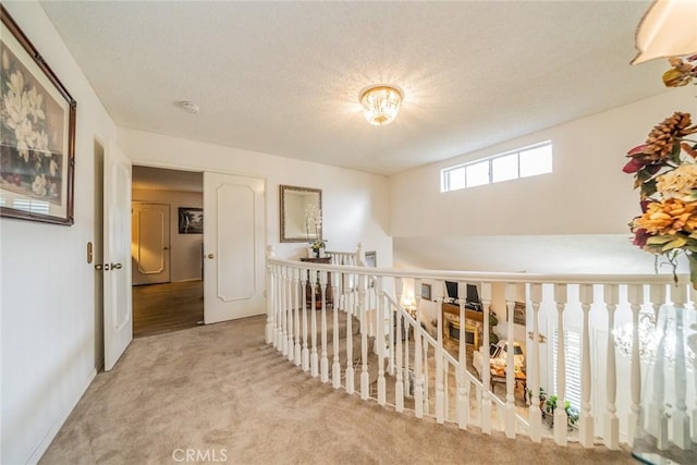 9527 Manzanita Dr, Rancho Cucamonga, CA 91737 - hall with carpet floors, an upstairs landing, and a textured ceiling