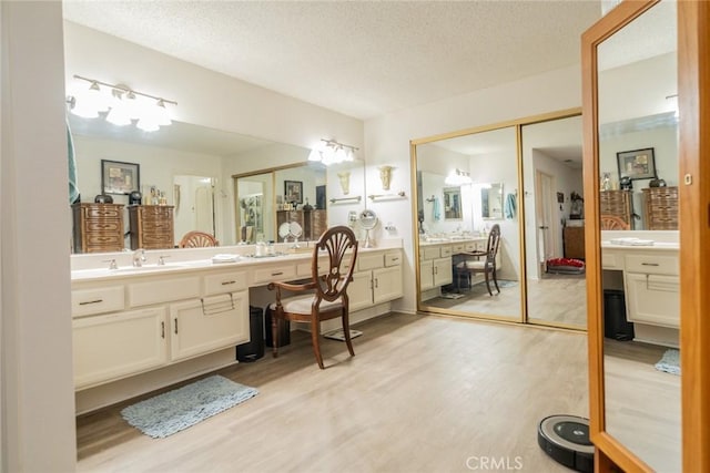 9527 Manzanita Dr, Rancho Cucamonga, CA 91737 - bathroom with wood finished floors, a textured ceiling, and vanity