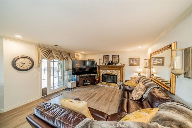 9527 Manzanita Dr, Rancho Cucamonga, CA 91737 - living area featuring light wood finished floors, baseboards, a glass covered fireplace, visible vents, and ornamental molding