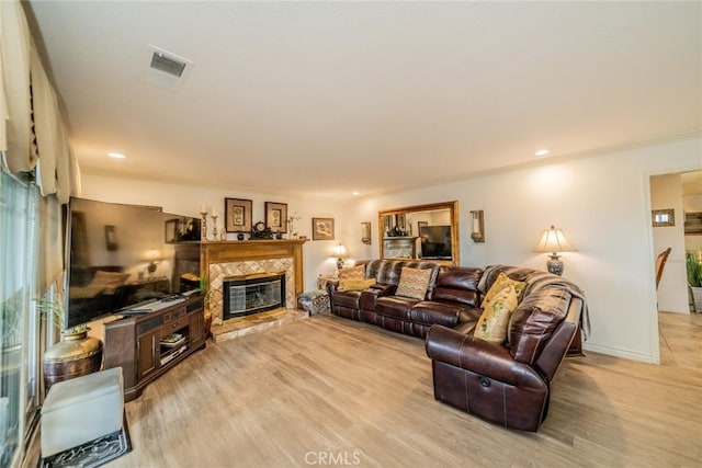 9527 Manzanita Dr, Rancho Cucamonga, CA 91737 - living room with a fireplace, visible vents, light wood finished floors, and ornamental molding