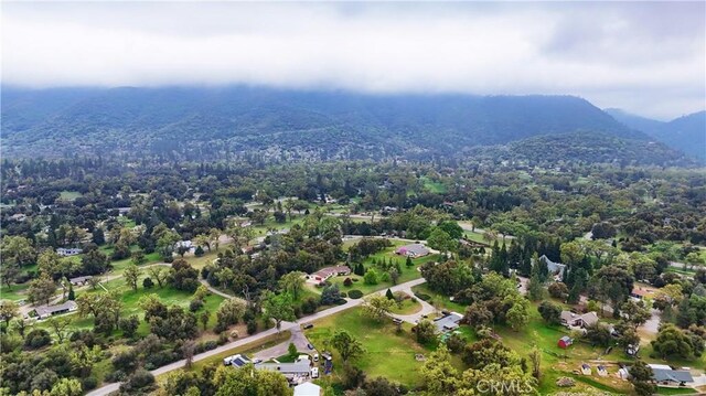 41820 Dillon Cir, Ahwahnee, CA 93601 - aerial overview of property's location featuring a mountain backdrop and a heavily wooded area