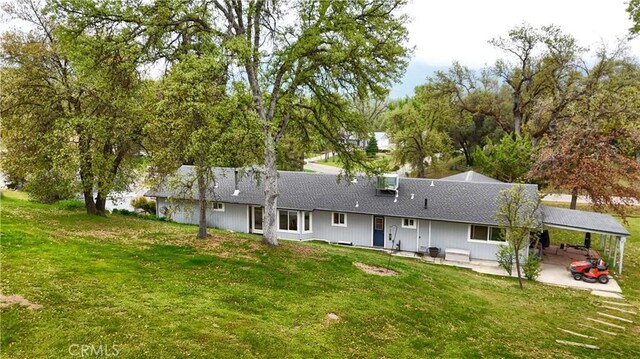 41820 Dillon Cir, Ahwahnee, CA 93601 - rear view of property featuring a yard, a carport, a patio, and roof with shingles