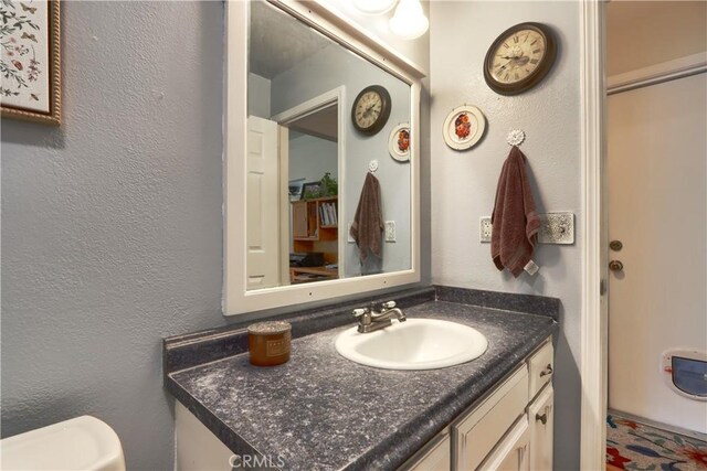 41820 Dillon Cir, Ahwahnee, CA 93601 - bathroom with vanity, a textured wall, and toilet