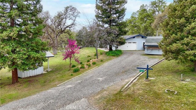 41820 Dillon Cir, Ahwahnee, CA 93601 - view of front of home with driveway, a garage, a front lawn, and an outbuilding