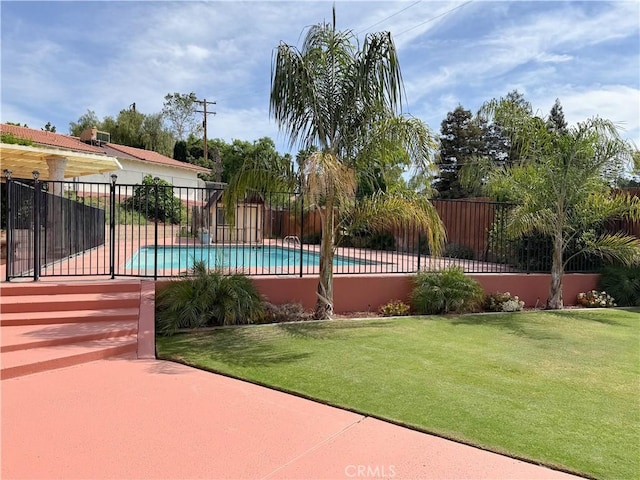view of swimming pool with fence, a lawn, and a fenced in pool
