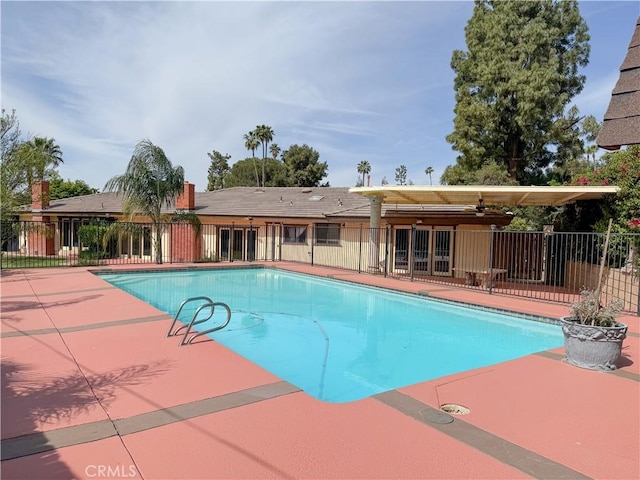view of swimming pool with fence, a patio area, and a fenced in pool