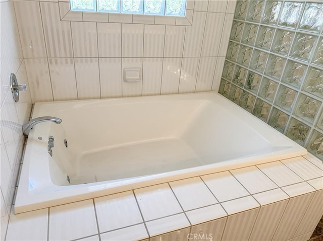 full bathroom with tiled bath and a shower