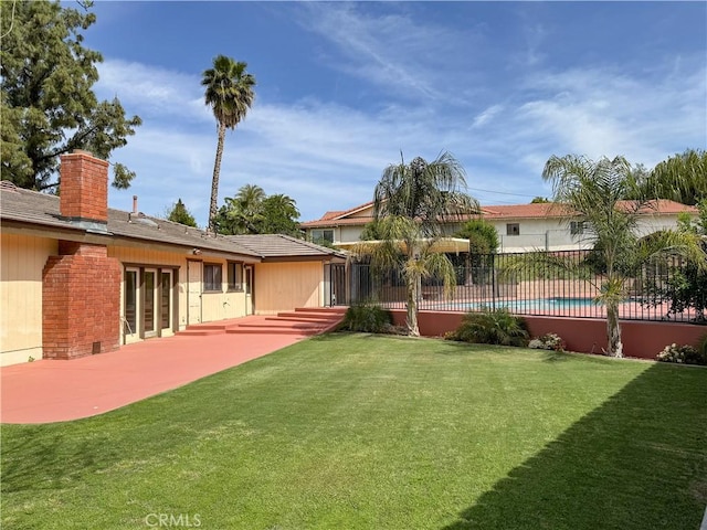 view of yard with fence and a patio area