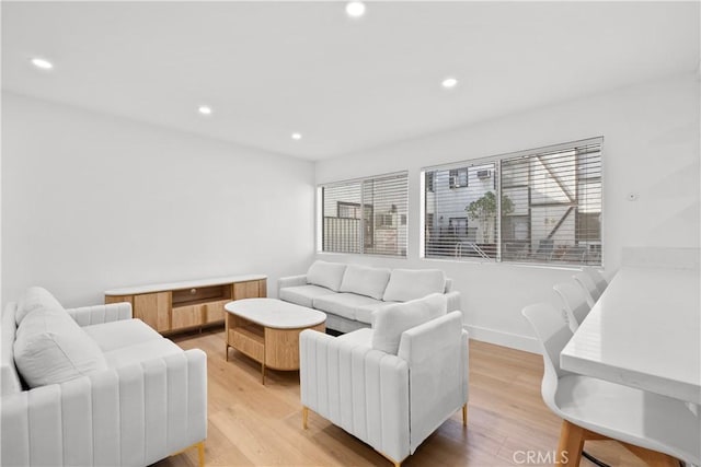 living room with recessed lighting and light wood-style floors