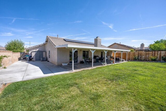 6030 Treehaven Ct, Lancaster, CA 93536 - back of property featuring solar panels, a patio, stucco siding, and a tile roof