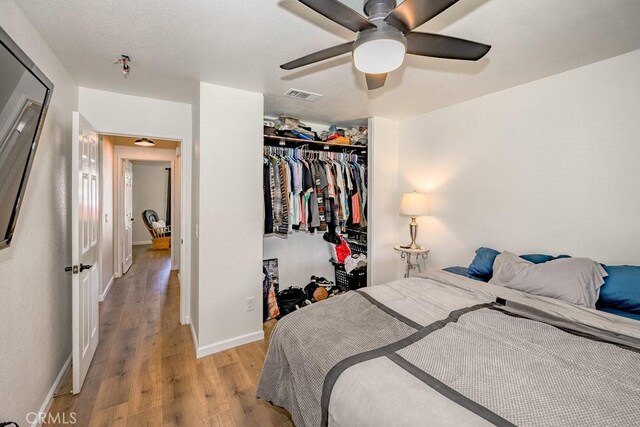 6030 Treehaven Ct, Lancaster, CA 93536 - bedroom with light wood-style floors, a closet, baseboards, and ceiling fan
