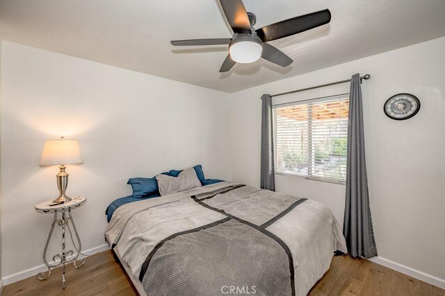 6030 Treehaven Ct, Lancaster, CA 93536 - bedroom with light wood finished floors, baseboards, and a ceiling fan