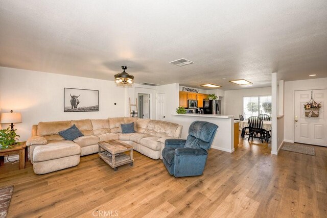 6030 Treehaven Ct, Lancaster, CA 93536 - living room with light wood-style flooring and baseboards