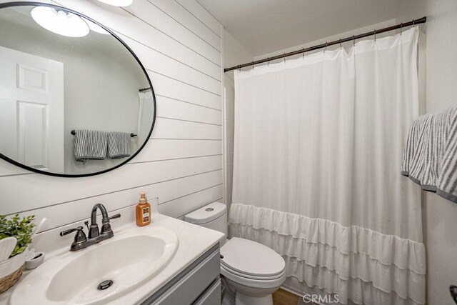 6030 Treehaven Ct, Lancaster, CA 93536 - full bath featuring toilet, vanity, wood walls, and a shower with curtain