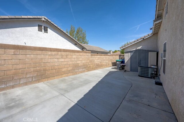 6030 Treehaven Ct, Lancaster, CA 93536 - view of patio with a shed, central AC unit, a fenced backyard, and an outdoor structure