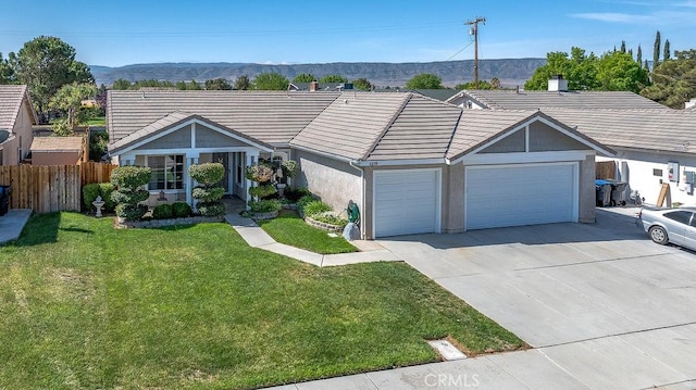 6030 Treehaven Ct, Lancaster, CA 93536 - single story home featuring a garage, a tiled roof, driveway, stucco siding, and a mountain view