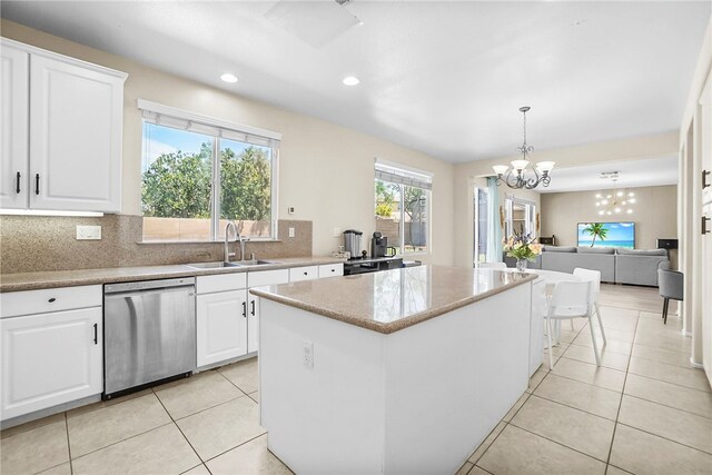 13608 Sagemont Ct, Eastvale, CA 92880 - kitchen featuring dishwasher, a center island, a chandelier, tasteful backsplash, and white cabinets