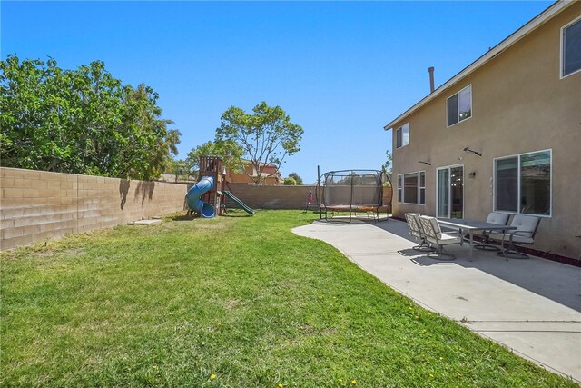 13608 Sagemont Ct, Eastvale, CA 92880 - fenced backyard with a trampoline, a playground, and a patio