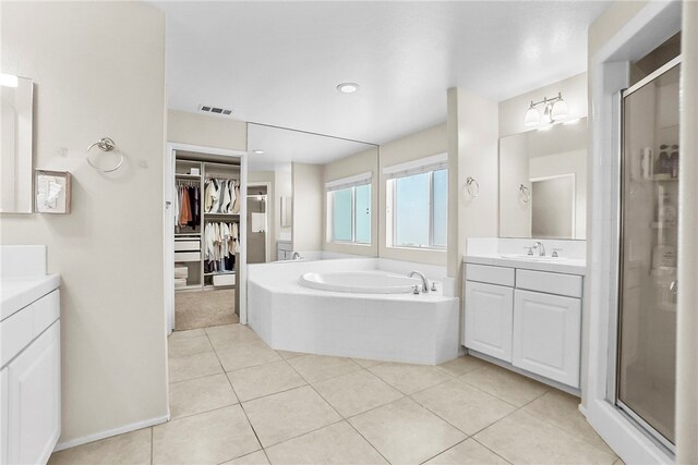13608 Sagemont Ct, Eastvale, CA 92880 - bathroom with two vanities, a stall shower, a bath, and recessed lighting