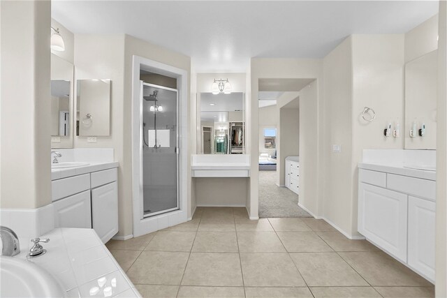 13608 Sagemont Ct, Eastvale, CA 92880 - ensuite bathroom featuring a shower stall, two vanities, and tile patterned flooring