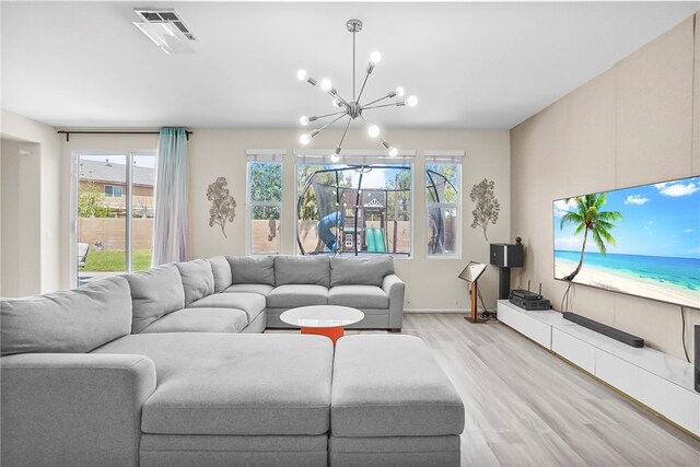 13608 Sagemont Ct, Eastvale, CA 92880 - living area with a chandelier, light wood finished floors, and healthy amount of natural light