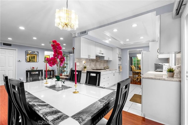 3010 Stoner Ave, Los Angeles, CA 90066 - dining space with visible vents, an inviting chandelier, and crown molding