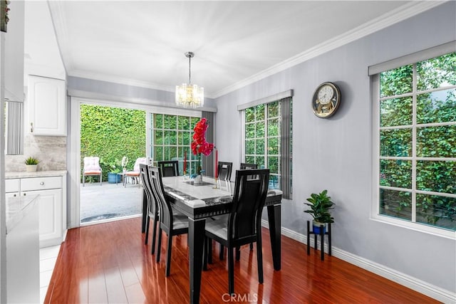 3010 Stoner Ave, Los Angeles, CA 90066 - dining area featuring wood finished floors, crown molding, baseboards, and an inviting chandelier