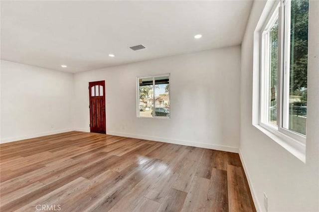 interior space featuring recessed lighting, light wood-style flooring, visible vents, and baseboards