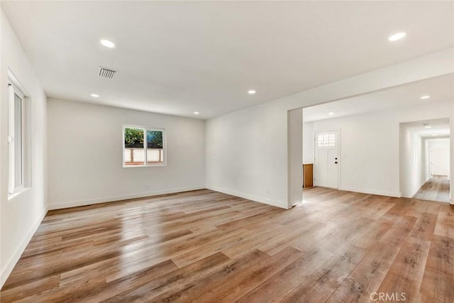 unfurnished room featuring light wood-type flooring, baseboards, visible vents, and recessed lighting