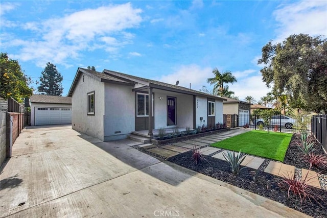 ranch-style house with a garage, a front lawn, fence private yard, and stucco siding