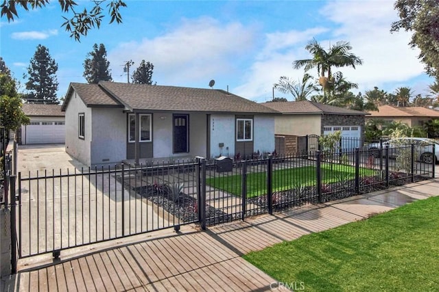 ranch-style house with a fenced front yard, driveway, a front yard, and stucco siding