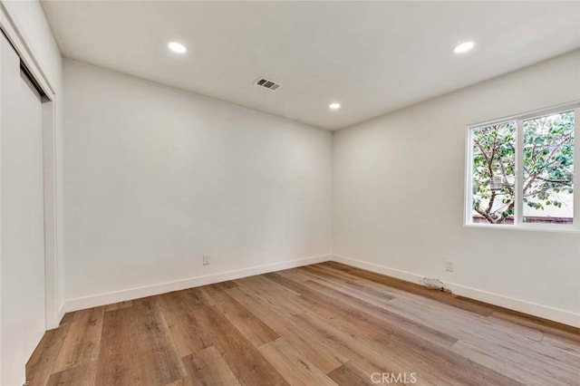 unfurnished room with visible vents, recessed lighting, and light wood-style floors