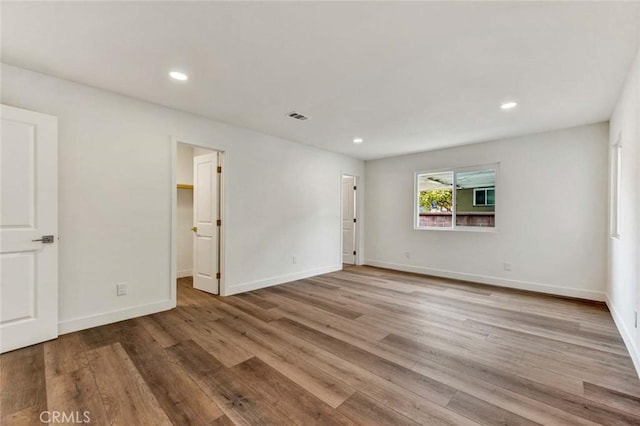 spare room featuring recessed lighting, baseboards, visible vents, and light wood-type flooring