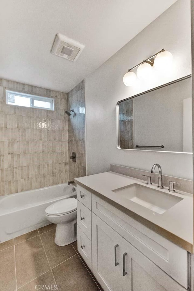 full bath with tile patterned floors, toilet, visible vents, vanity, and shower / tub combination