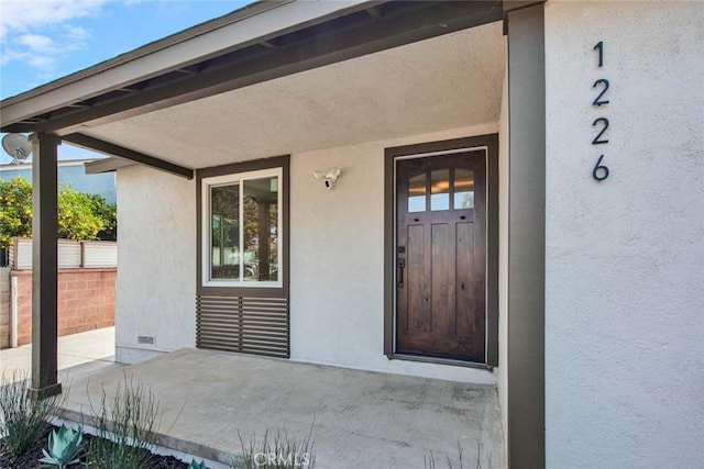 property entrance featuring crawl space and stucco siding