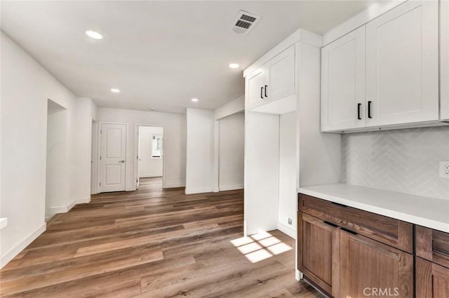 kitchen with white cabinets, visible vents, recessed lighting, and tasteful backsplash
