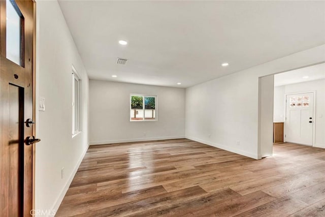 spare room with baseboards, recessed lighting, visible vents, and light wood-style flooring
