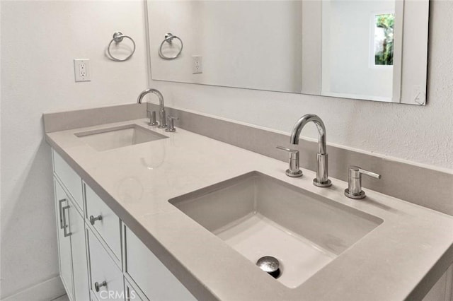 interior space with a sink and double vanity