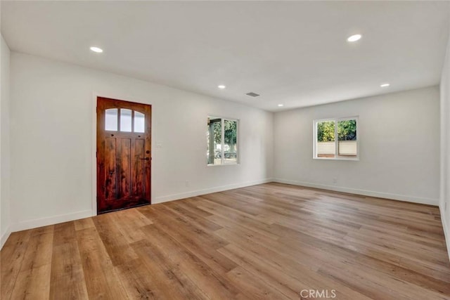 empty room featuring a wealth of natural light and recessed lighting
