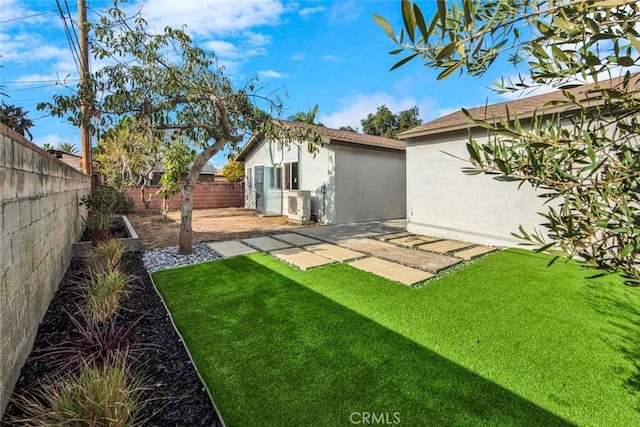 view of yard with a patio area, a fenced backyard, and ac unit