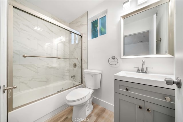 3721 S San Pedro St, Los Angeles, CA 90011 - full bathroom featuring shower / bath combination with glass door, wood finished floors, toilet, vanity, and baseboards